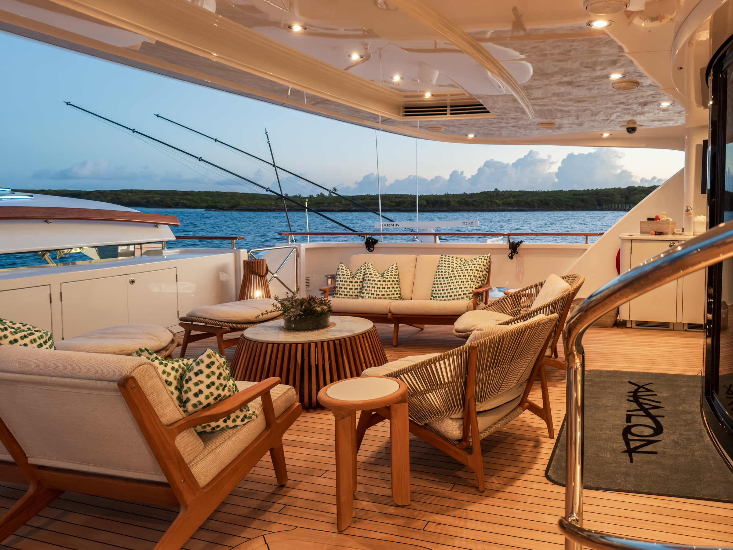 Aft deck lounge and dining setting at golden hour aboard Motor Yacht Avalon
