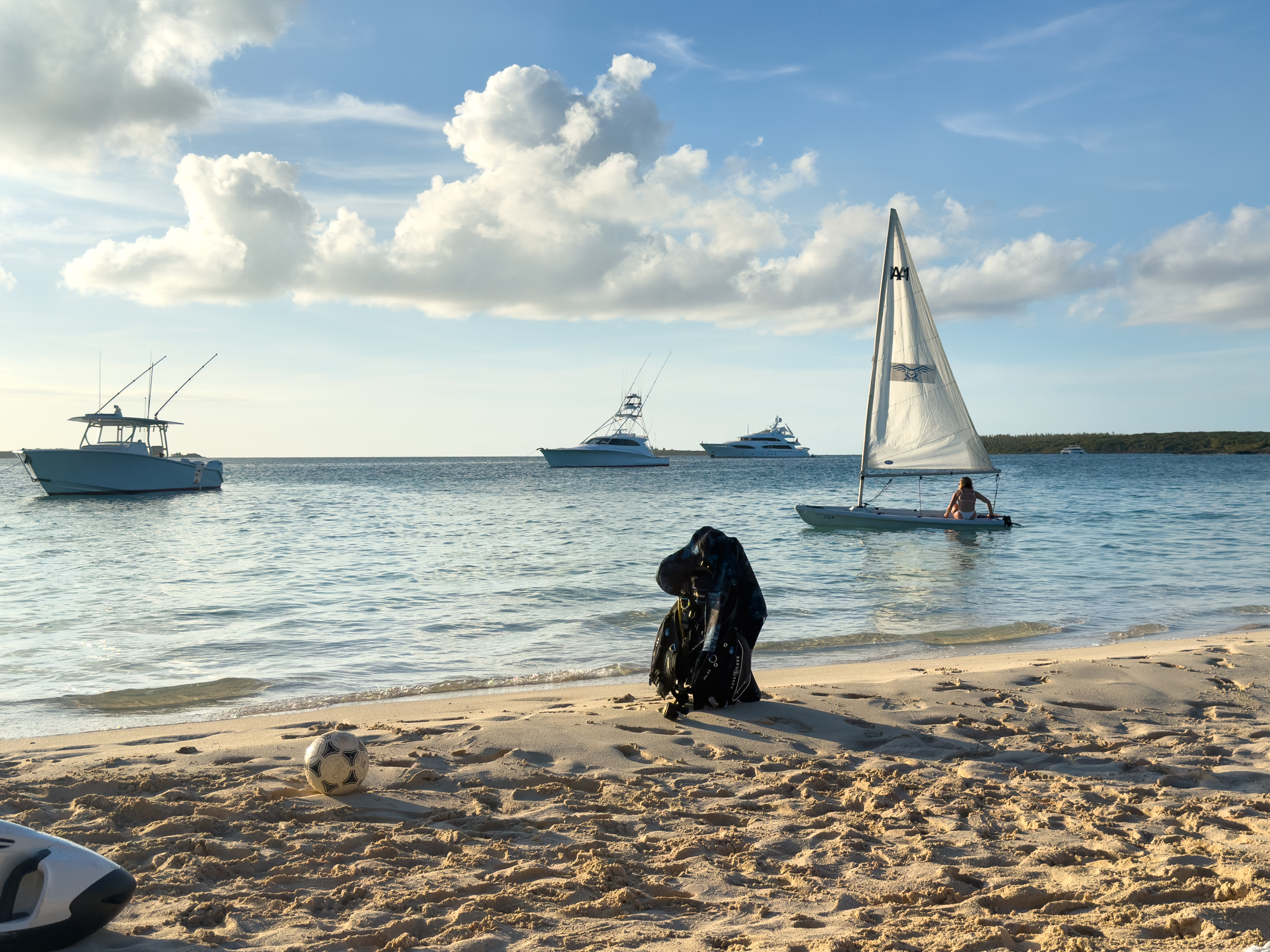 Bahamian beach at sunset with Avalon's sportfish tender and sailing dinghy