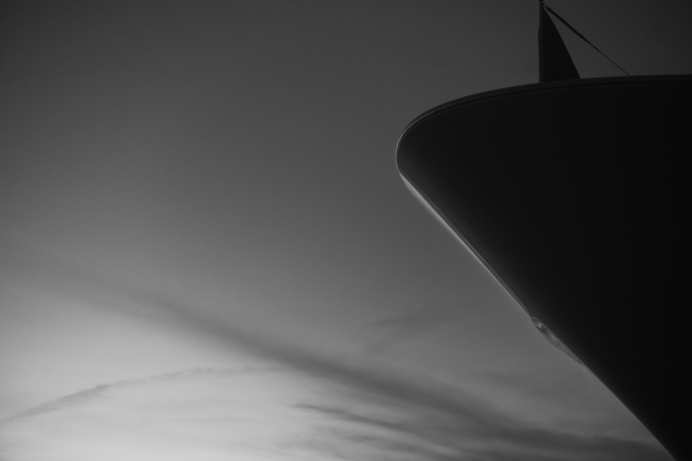 Cinematic silhouette of Motor Yacht Avalon's bow against an open sky