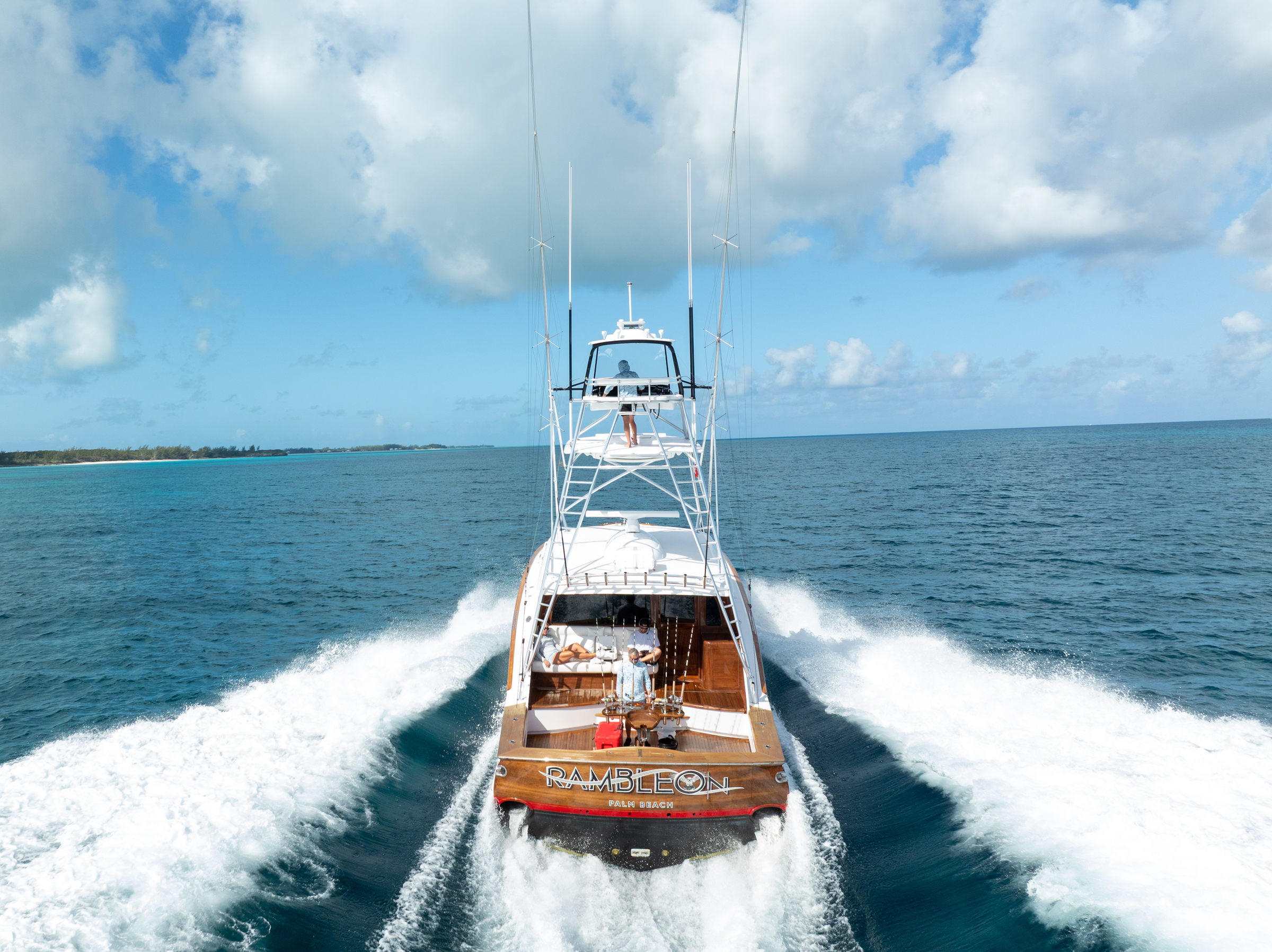 Sportfish tender running on a turquoise sea, full wake astern