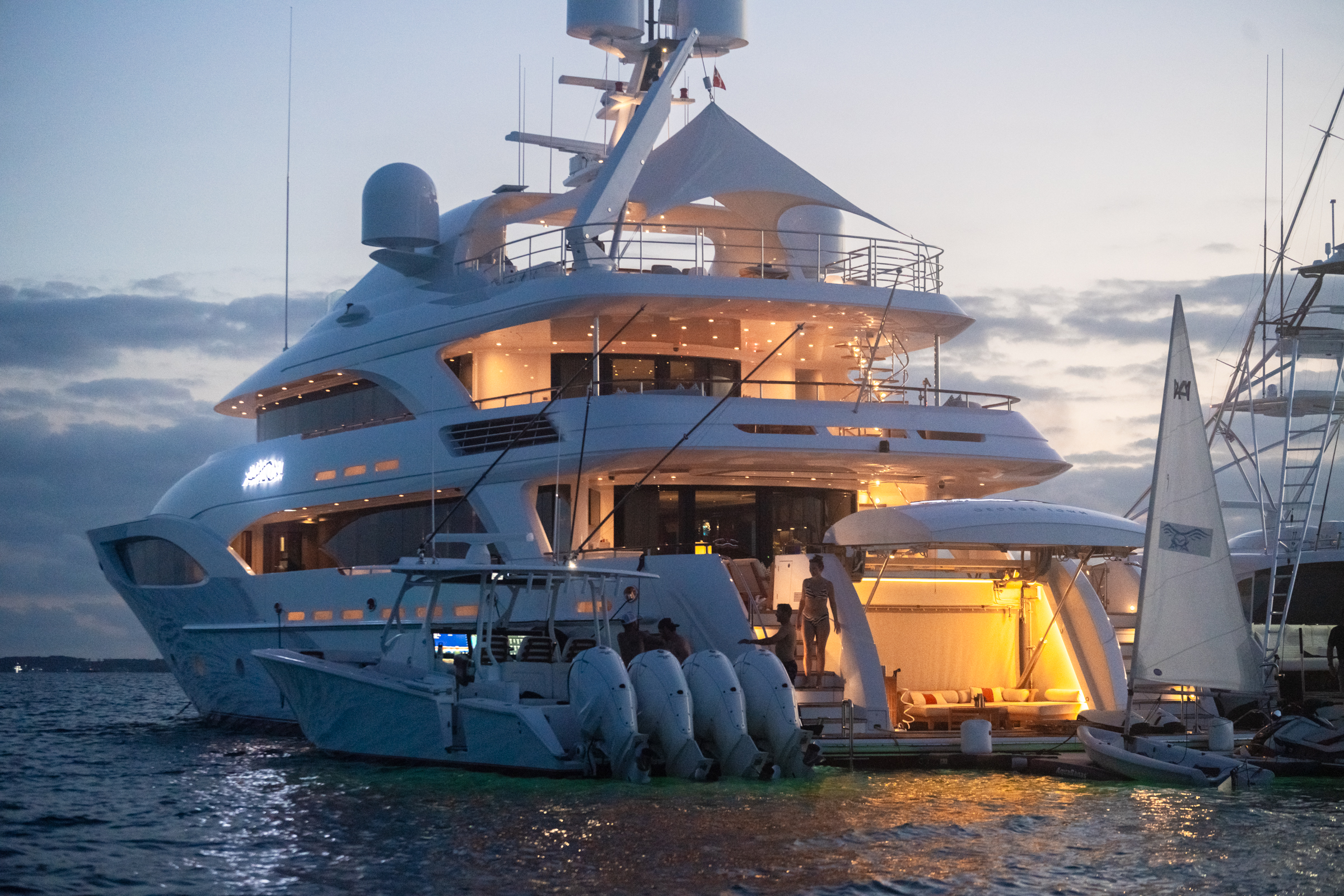 Motor Yacht Avalon at her berth at twilight, beach club warmly lit